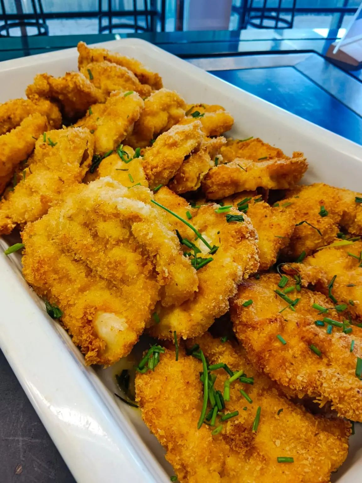 Crisp crumbed fish arranged on a buffet platter